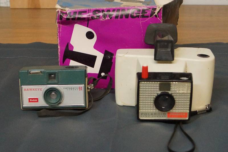 lot 1124 image: Vintage Cameras- Polaroid The Swinger and Kodak Hawkeye  Add To or Start A Collection