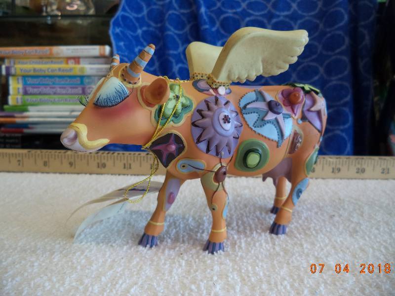lot 1626 image: Crazy Looking Cow Figurine- Cow Parade- This One Has Wings