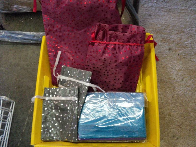 lot 1025 image: Mixed lot of small shopping bags.  perfect for crafts or jewelry.  (3)packages plastic bags, (4) gossamer fabric bags,  assorted sizes