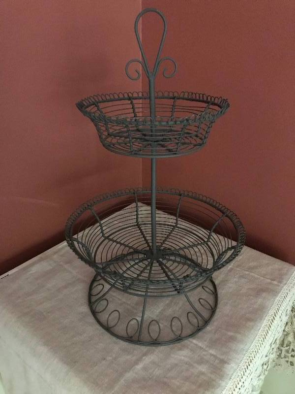 lot 219 image: 2 tier metal baskets-oil rubbed bronze measuring 20 height.  Bottom basket is 12 across