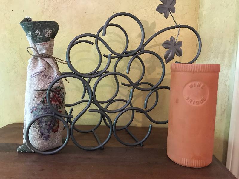 lot 241 image: Grape shaped metal wine rack, cloth wine bottle holder, and terra cotta wine bottle holder