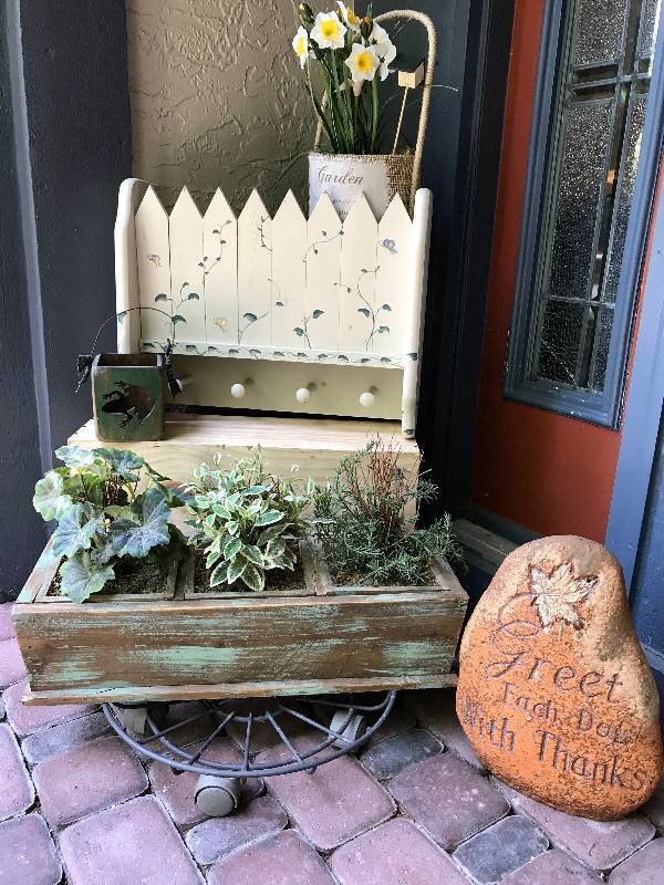 lot 247 image: Garden dcor items---Metal Plant Stand with Wheels, Wood Box display, shelf with pegs, Great Each Day Rock, etc.