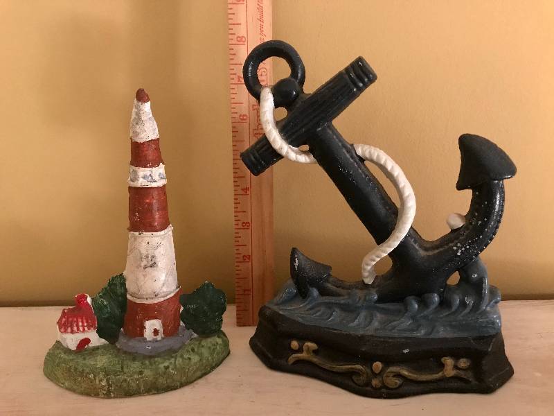 lot 1084 image: Anchor and Lighthouse cast iron door stops