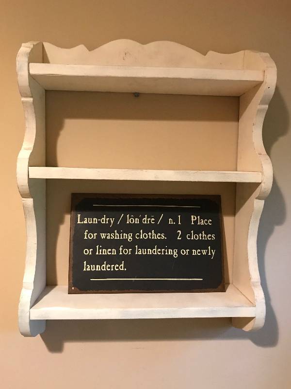lot 15 image: Rustic painted wood shelf and tin laundry sign