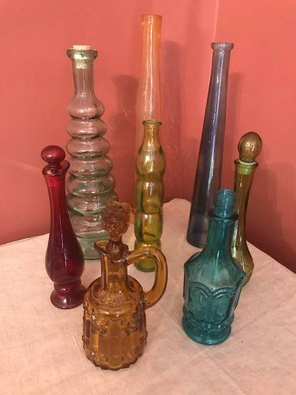 lot 47 image: Assorted colored unique shaped bottles (some with stoppers).  Tallest bottle is 11