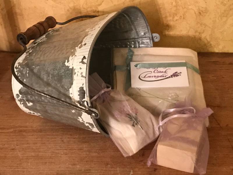 lot 195 image: Galvanized bucket and Lavender items (dryer sachet, soap) from Washington Creek Lavender outside of Lawrence, KS
