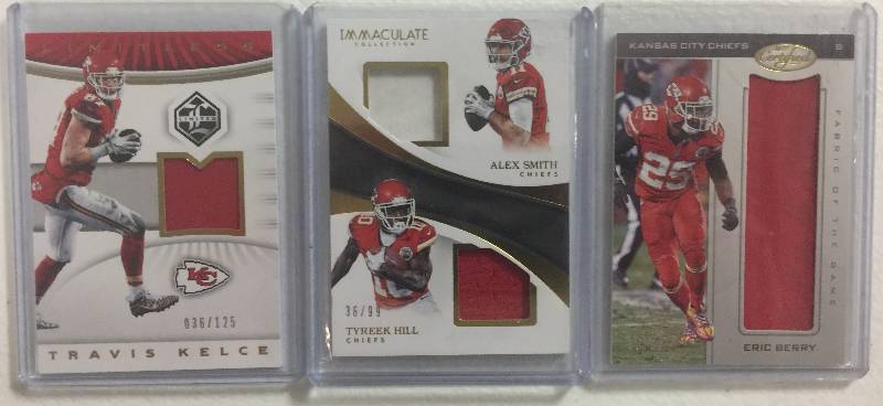 lot 1283 image: Three Kansas City Chiefs Player Worn Jersey Relic Football Cards - Travis Kelce, Eric Berry, & Tyreek HillAlex Smith Dual Pieces