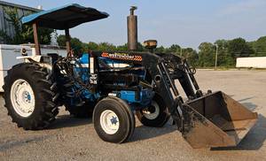 lot 40 image: One Owner Ford 7600 Diesel 96HP Tractor, Two Speed(HighLow) 16 Gear Powershift Transmission w Westendorf Loader TA-26 Front End Loader w 72in Bucket & Bale Spear - Joystick Control - Approx 3300 Original Hours
