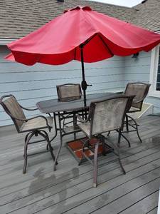 lot 900 image: High top patio table 38 x 65 x 36, 4 swival chairs and crank up umbrella with stand