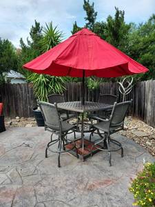 lot 912 image: High top patio table 41 x 44 x 44 with 4 chairs and crank up umbrella with stand