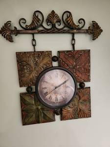 lot 1010 image: Metal decor wall clock 24 x 24, located in basement