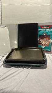 lot 1211 image: Broiler pan, several cooking sheets and two plastic Pizza Hut trays