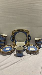 lot 1248 image: Vintage Blue and Gold Porcelain Tea Set  - 5 cups, 6 small saucers, 6 small bowls, creamer, sugar bowl and small tray
