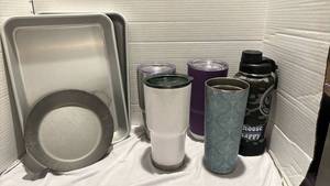 lot 1250 image: Two cake pans, 5 travel cups - 4 have lids, and small round pan