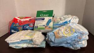 lot 1305 image: Finding Nemo Swim Diapers Size 5-6 Large and Curad Cast Protector Bundle