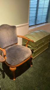 lot 2003 image: Vintage antique wooden arm chair and green antique vintage trunk IN BASEMENT