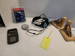 lot 3215 image: Stone bookends, Santa Disk flash drive new, headphones and calculator