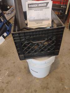 lot 3713 image: 5 Gallon Bucket with Crate Filled with Black and Decker Blower Parts