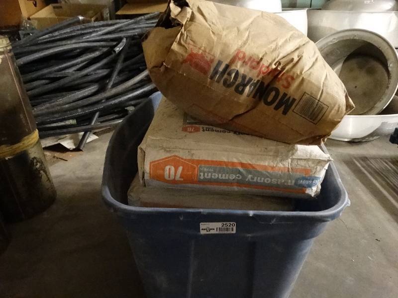 lot 2520 image: 4 bags of masonry cement. 1 bag of Portland Cement.
