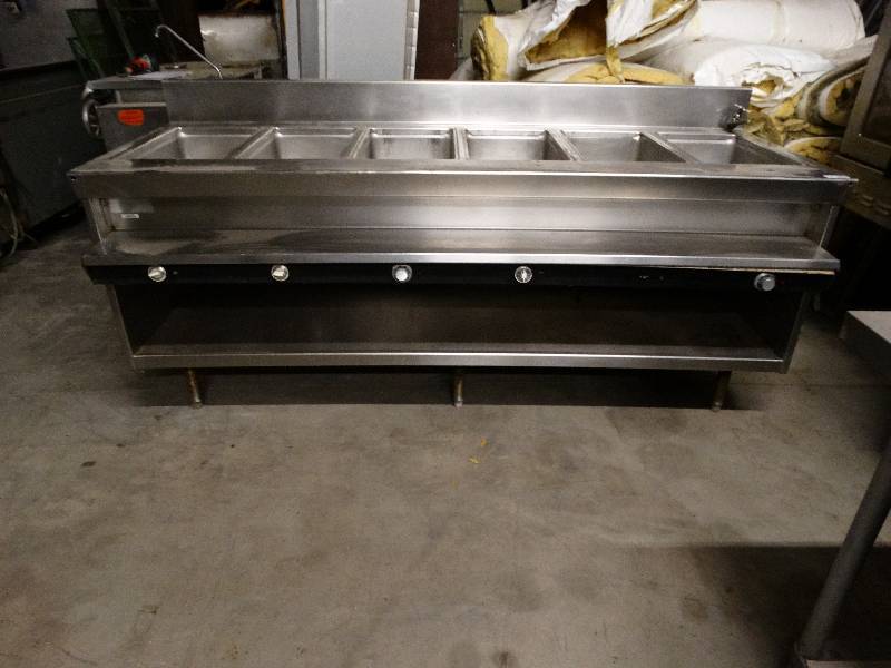 lot 2532 image: Wells 7 warming table. Holes in end of table to allow for pegs on another table or unit to connect.