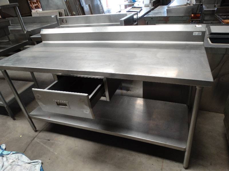 lot 2559 image: 6W x 30D x 36T Stainless steel table with backsplash, lower shelf and drawer mounted center under table top.