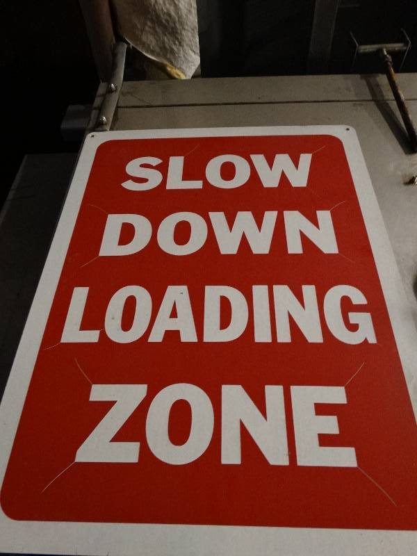 lot 2590 image: Slow down loading zone signs. 18 x 24