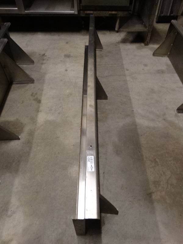 lot 2601 image: 1 only. Stainless steel shelf. Only the shelf centered in the picture dor sale. The two shelves on partially pictured ore not included.