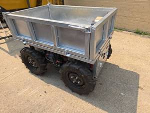 lot 64 image: Unused Heavy Duty Motorized Utility Dump Cart  Remote Control