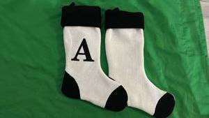 lot 534 image: 2 Black and White Christmas Stockings 1 with and A and 1 Plain