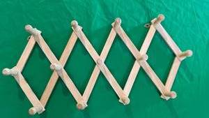lot 588 image: Expandable Wooden Peg Rack - Retail $15