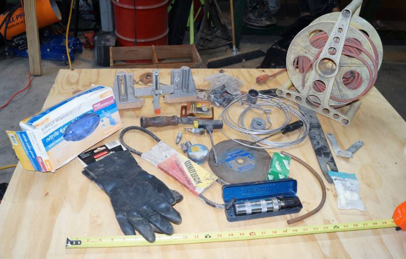 lot 2453 image: Misc Lot - Contents on Table - Gloves - Ext. Cord and Reel - Grinding Wheel and More
