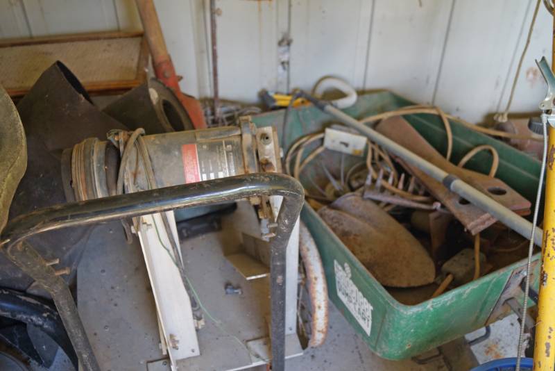 lot 2678 image: Contents of Shed Shown in Picture - Weed Barrier, Rakes, other lawn care stuff and more.