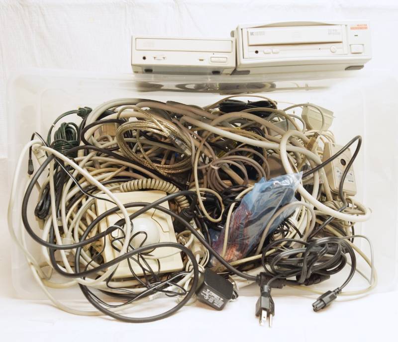 lot 2063 image: Lots of vintage cd drive , mouse in many various cables and power cords in a tub