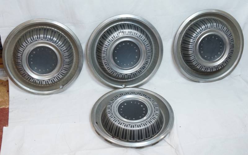 lot 1441 image: CAR PARTS - Set of 4 Vintage Plymouth Hubcaps