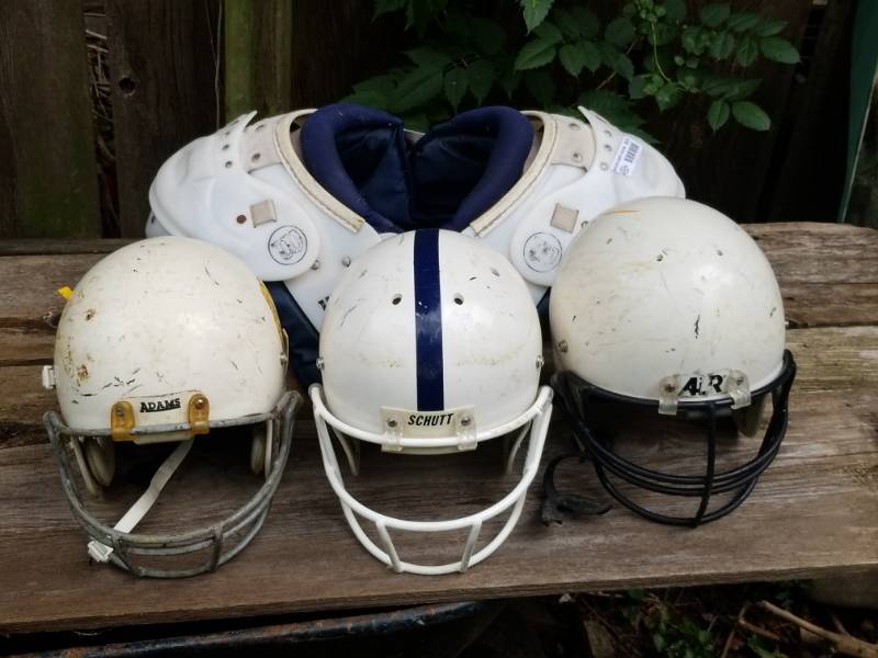lot 8070 image: Lot of  Football Items - 3 Helmets and a Set of Shoulder Pads