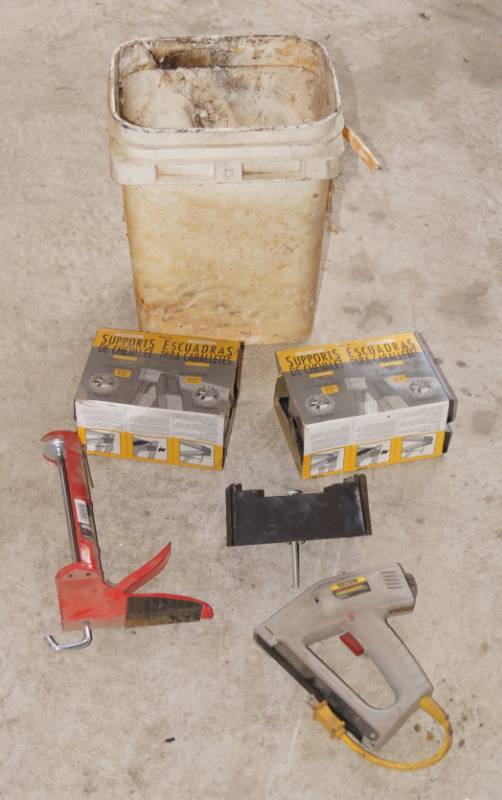 lot 5915 image: Lot of 2 Boxes of Sawhorse Supports, Stanley Electric Heavy Duty Sharpshooter TRE500, and caulking gun