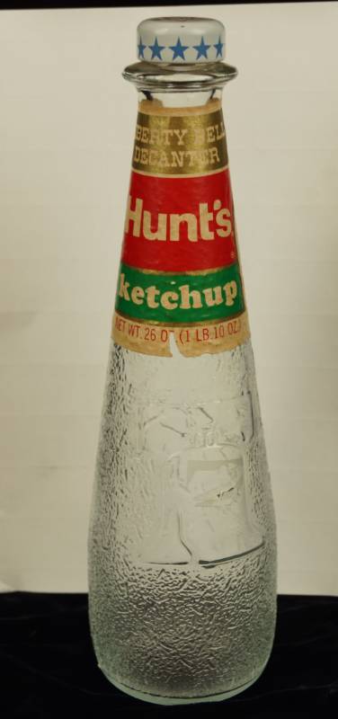 lot 6018 image: Vintage Hunts Ketchup Decanter - Glass - Liberty Bell Bottle w label
