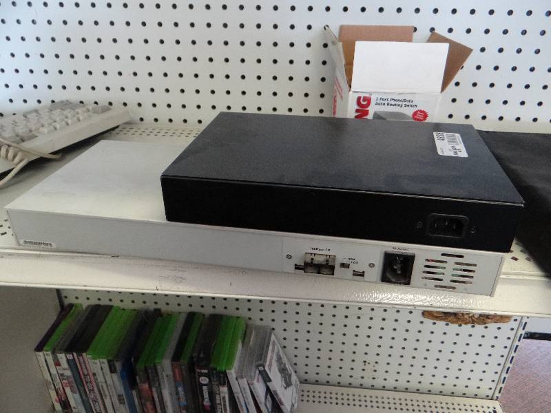 lot 4838 image: Two 24 port ethernet switches, compute keyboard, Viking 2 port phonedata auto routing switch, & smoke alarm