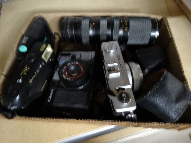 lot 13291 image: Vintage cannon cameras with attachments.