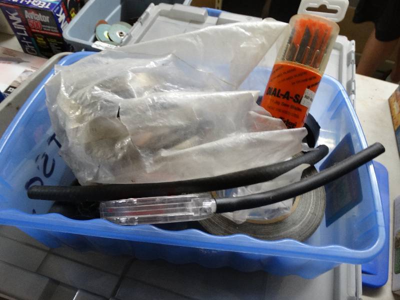 lot 13322 image: Duct tape, hose clamps, jigsaw blades in tote.