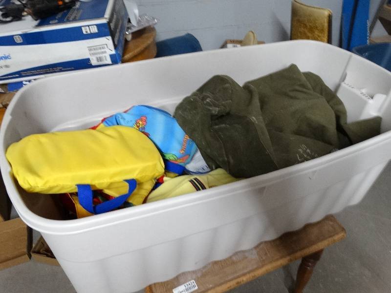 lot 13425 image: Large tote full of life jackets, clothes, plastic, ect.