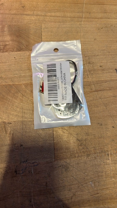 lot 1022174 image: The keychain is made of stainless steel, which is described as eco-friendly and safe. It will not fade, distort, or harm health. The dimensions are 10  3  0.5cm