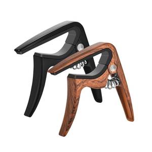 lot 18054 image: Ukulele Capo, 2 Pack for All Various Shapes - Professional, Buzzing-Free, Quick Release, Easy to Use, Lightweight Portable for Travel - Black and Rosewood