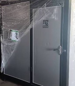lot 4156 image: Unused KJ 7ft 4in x 5ft x 8ft Portable Restroom K1522 DOOR WAS DENTED DURING SHIPPING SEE PHOTO FOR DETAILS
