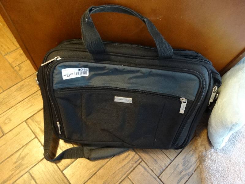 lot 8015 image: Brief case and a pillow.