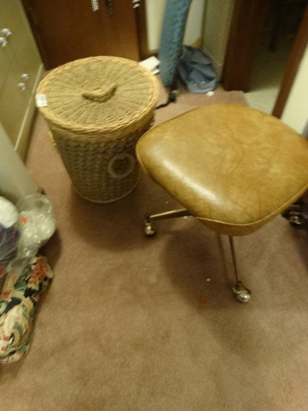 lot 8104 image: Basket filled with yarn and a chair on wheels.