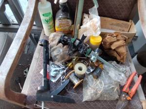 lot 261 image: Fishing line, grease lighting, lotion, trimmer and caulk gun.