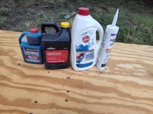 lot 297 image: Chemicals, hoover expert guard, ceramic tile caulk, small engine oil and 2-cycle engine oil.