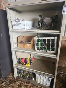 lot 56410 image: Vintage Metal Industrial Storage Shelving Unit with miscellaneous items and a Cummins Bench Grinder
