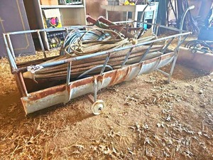 lot 56458 image: Vintage CattleLivestock Metal Feed Trough with lasso, jack stands and hose with reel